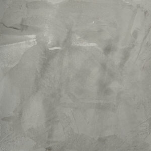 Eine edle graue Wand zeigt die kunstvolle Textur von STUCCORINO Kalkputz, perfekt für kreative Wandgestaltung.